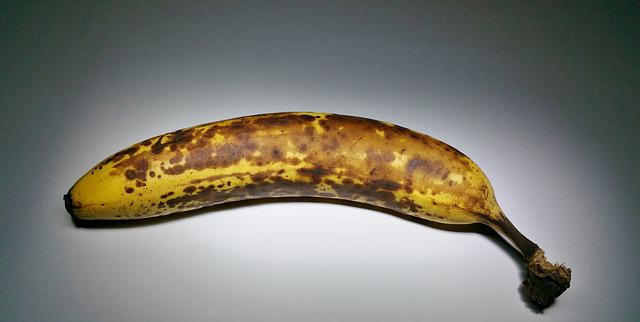 An Overripe Banana Highlighted on a Black Background